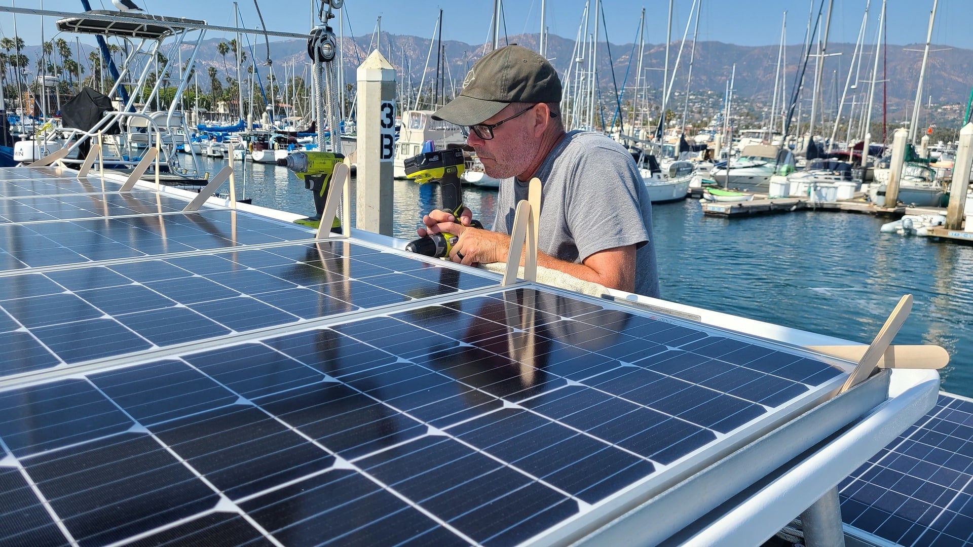 man working on solar panel|Keystone Cougar RV with Solar Panels on Top in the Snow|battle born solar panel