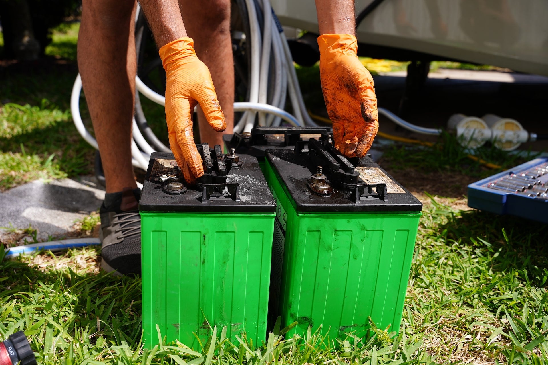 damaged lead acid batteries|Man Wearing Protective Gear While Lifting a Lead Acid Battery Out of An RV|Danger Warning Label on a Lead Acid Battery|Lead Acid Batteries Wired Into an RV