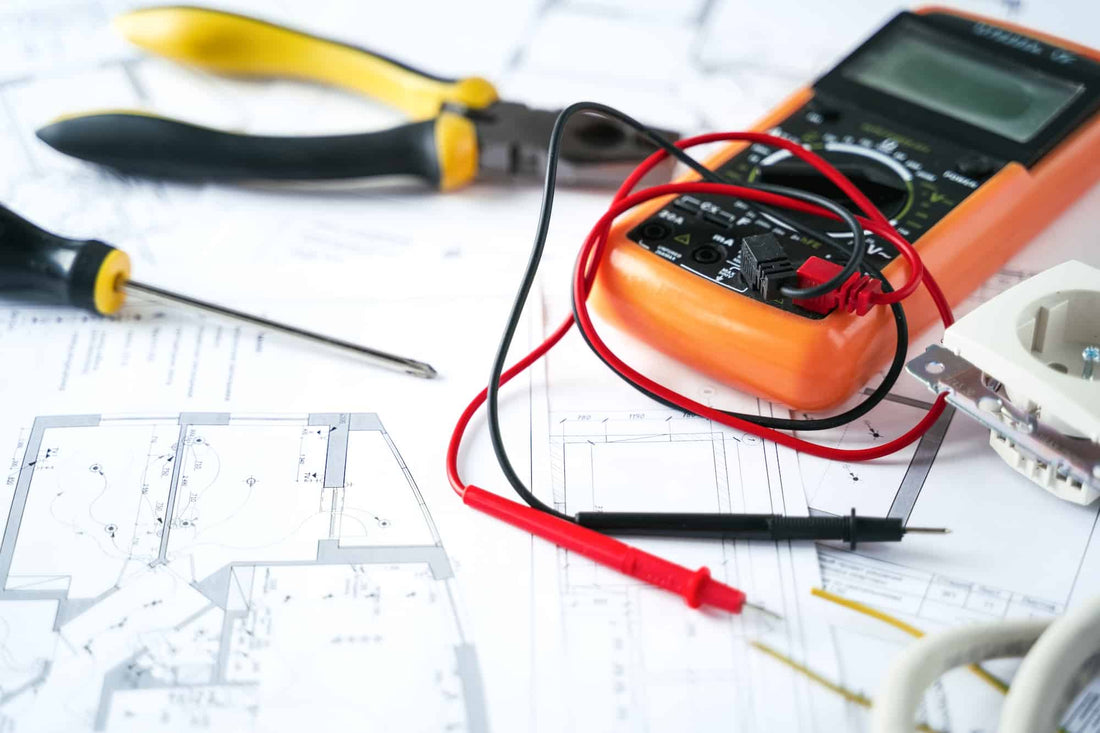 voltage drop featured|Cable cutter, electric cable and fuse on electrical drawing of house, engineer jobs concept|Multiple electricity plugs on adapter risk overloading and dangerous|Assistant and female customer with wires, diy