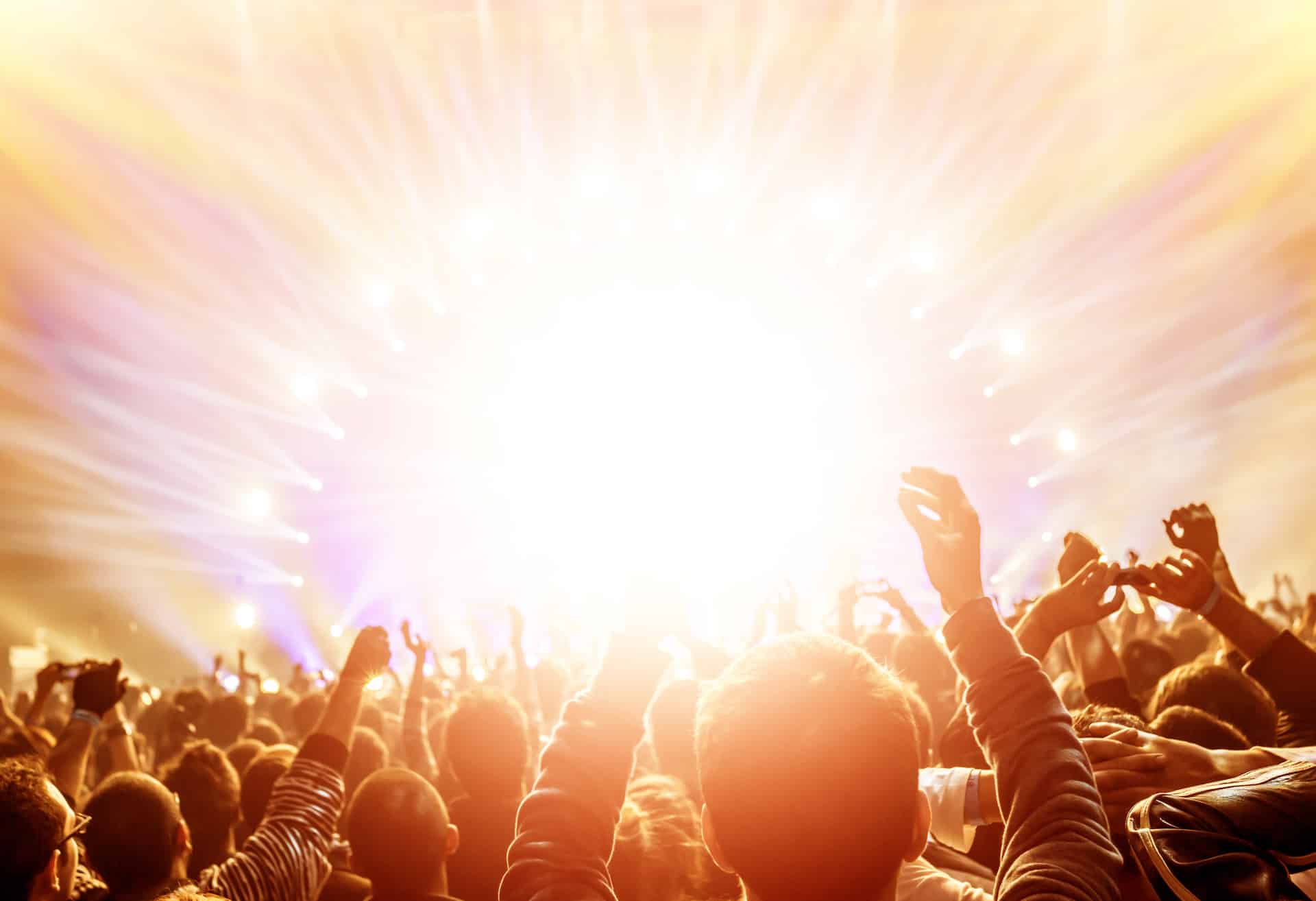 concert with lights that look like solar rays|Crowd at a Concert|Man playing guitar at night outdoor concert|Woman watching at stage during festival|Workspace In Recording Studio|Crowd at concert|Cheerful bearded man playing drums at outdoor concert