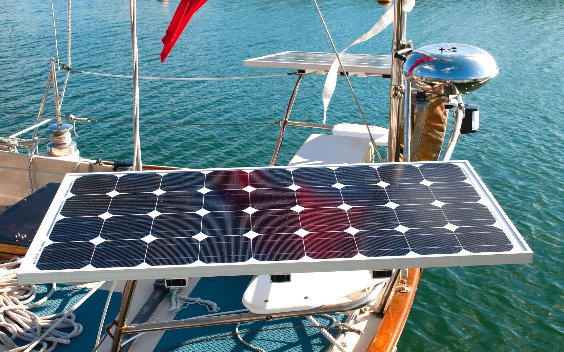 sailboat solar panels|Aerial drone photo of catamaran boat at blue clear ocean water|Aerial  view from drone of yacht in deep blue sea