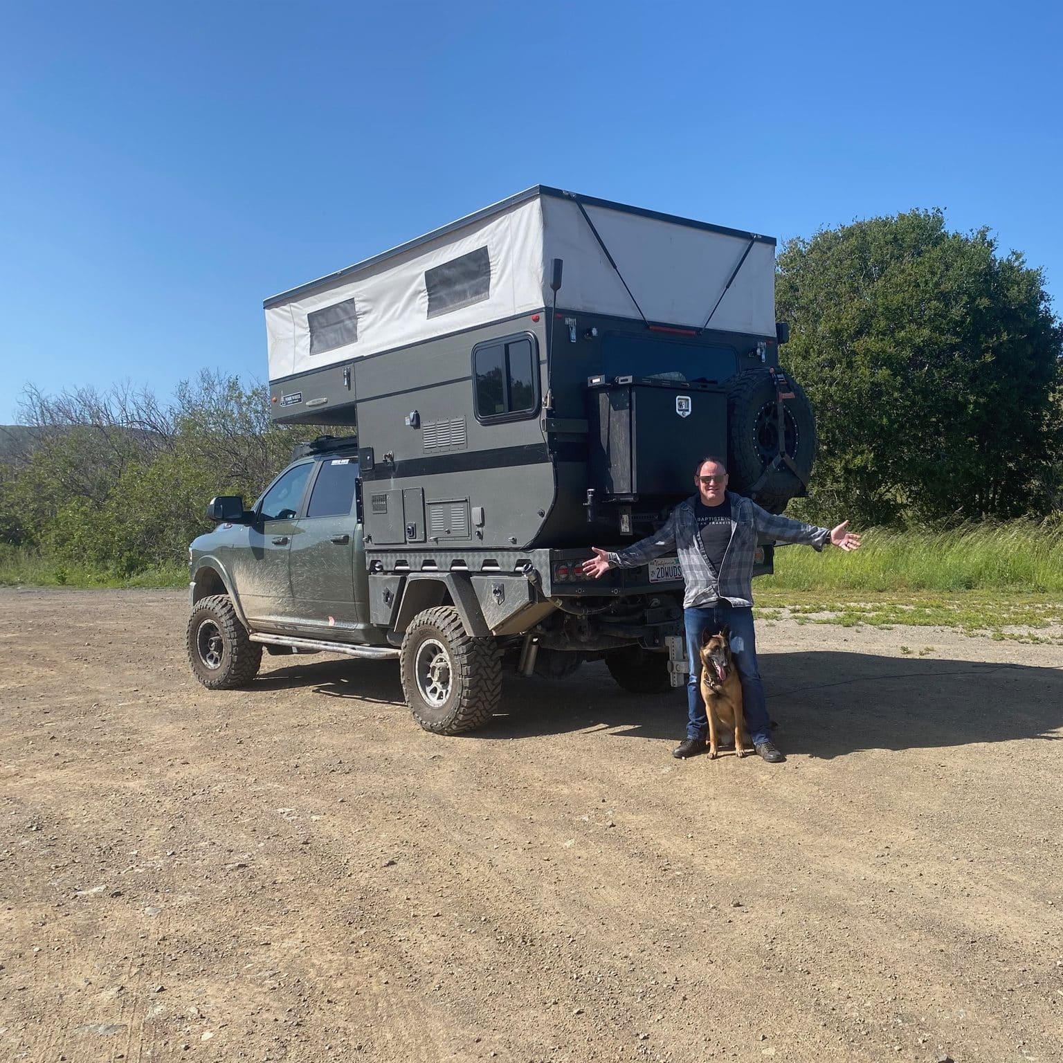 Sean Silvera and Dog Freya in Front of Their Truck Camper
