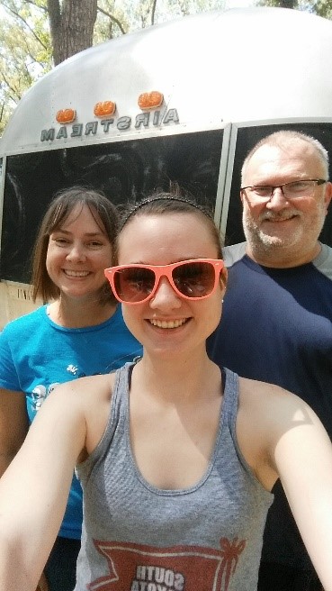 Karl and his two daughter smile for a selfie.