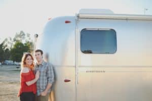 Marissa and Nathan standing in front of their Airstream.