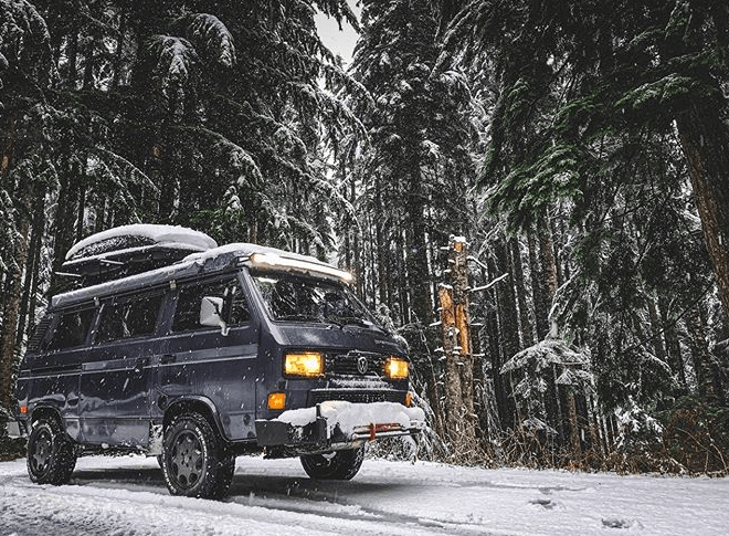 Chad DeRosa's Van in between snowy trees 