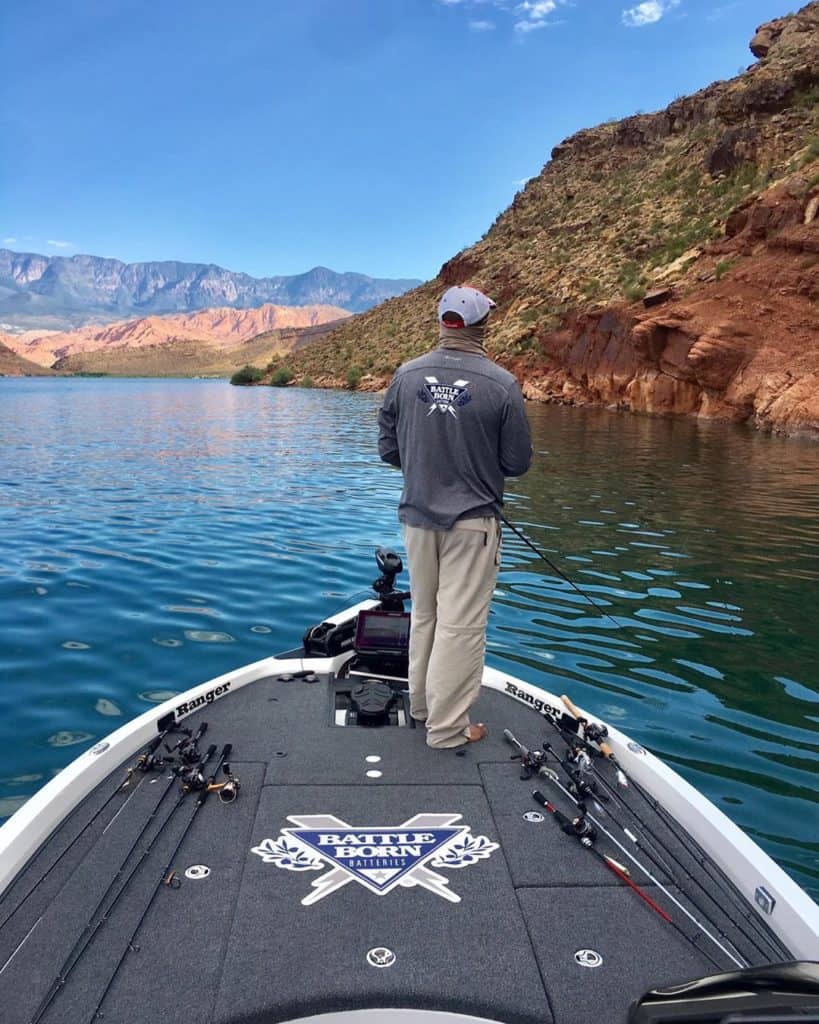 Darius Arberry wearing a Battle Born Batteries long sleeve while fishing on his Battle Born Batteries branded boat