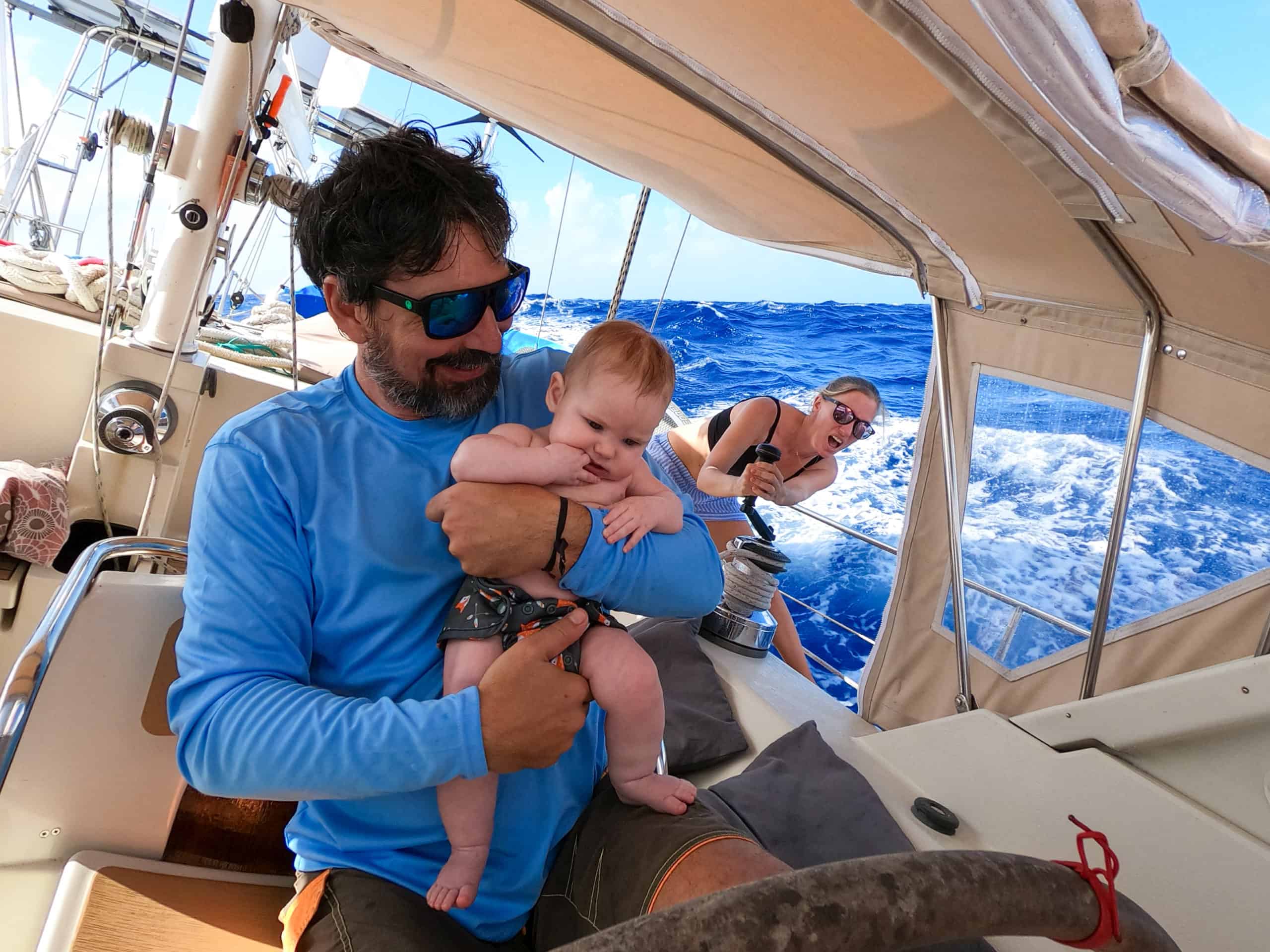 Brian holding Sierra while Karin sails their sailboat