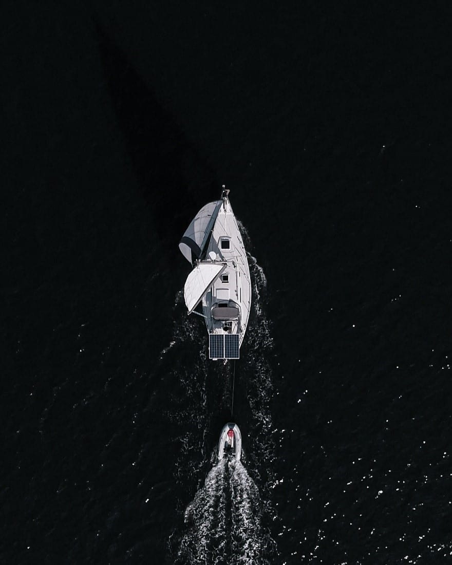 An overhead shot of a sailboat on the water.