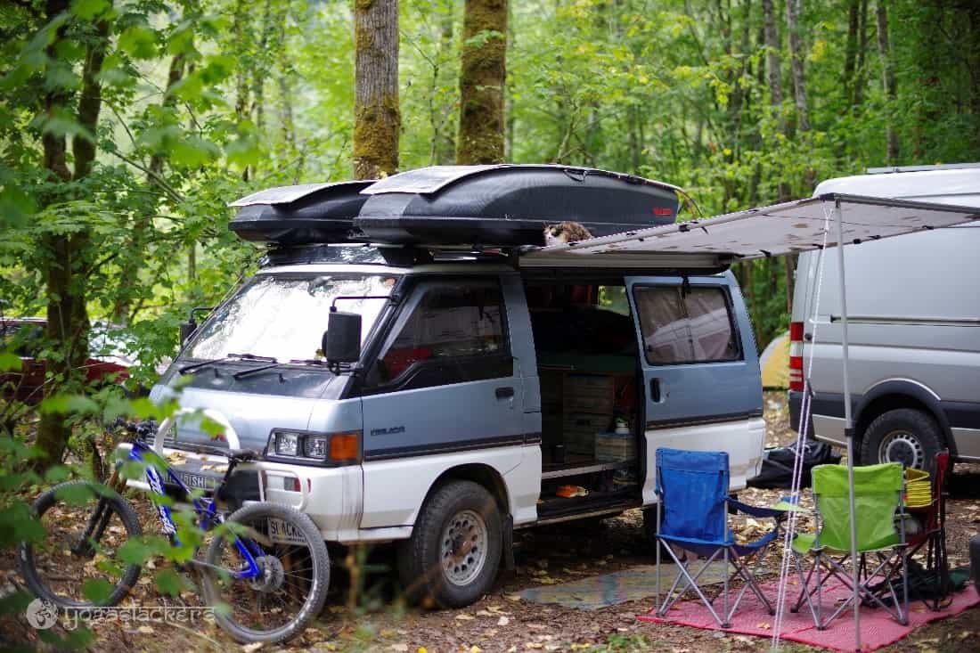 A van parked in the forest.
