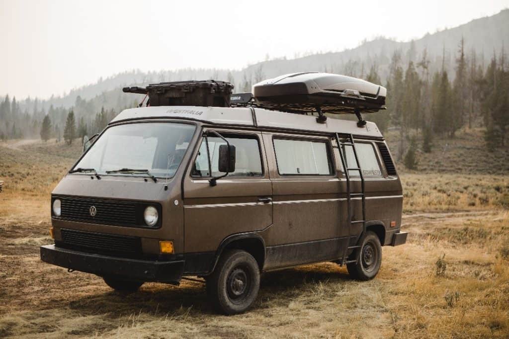 A van parked in the open field. 