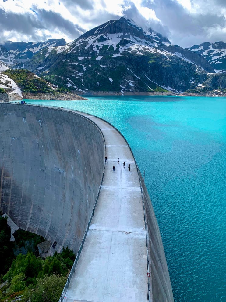 energy storage dam with a snowy mountain in the back