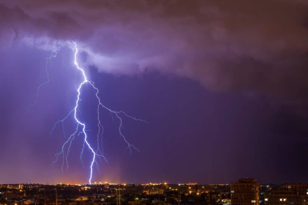 Lightning striking over a city at night