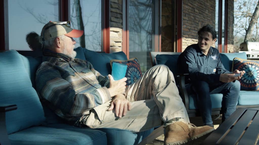 Rick Clunn sitting with Denis on a porch