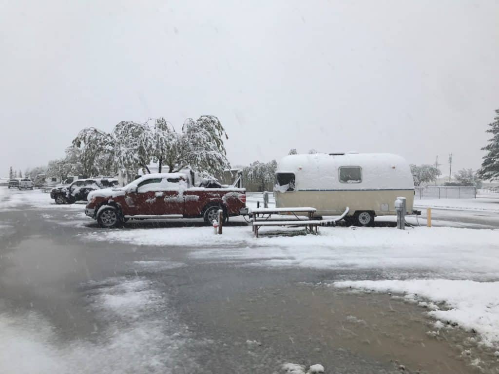 Zola the vintage camper stuck in the snow during a May 2019 snowstorm.