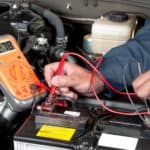 auto-mechanic-checking-car-battery-voltage-BGULM3J (Large)