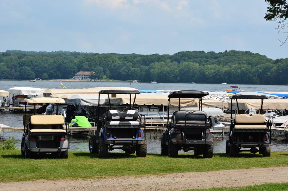 golf carts lined up at the lake