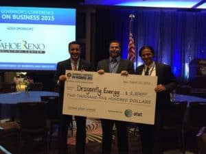 Denis holding a check that he won at the Sontag Entrepreneurship Competition at The University of Nevada, Reno 