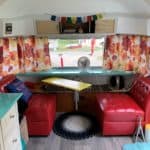 A nicely decorated picture of the inside of Zola, a 20-foot 1976 Airstream Argosy.