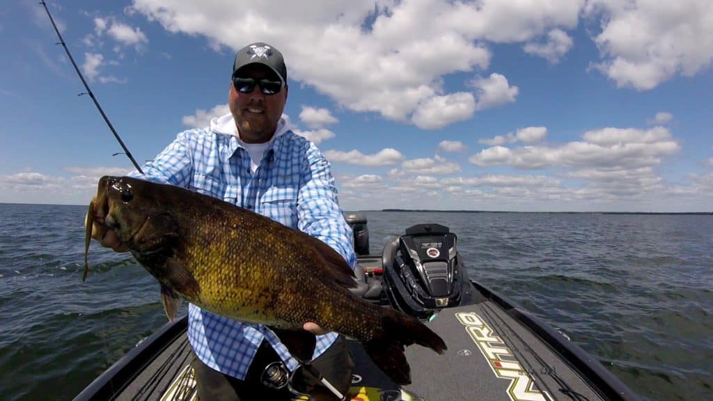 Jeremiah Johnson holding a fish that he caught.