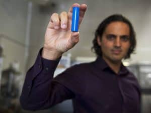 Dr. Denis Phares holding a lithium cell