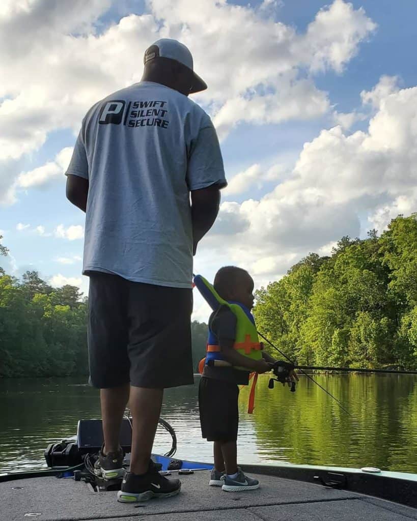 Wayman and his son fishing on the lake. 