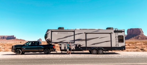 Janae and Tucker McCormick in front of their Keystone RV, a Montana High Country 335BH