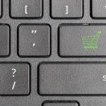 green shopping cart key on computer keyboard , online shopping concept