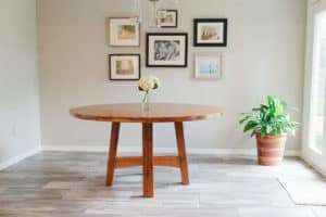 A round wooden table in a dining room