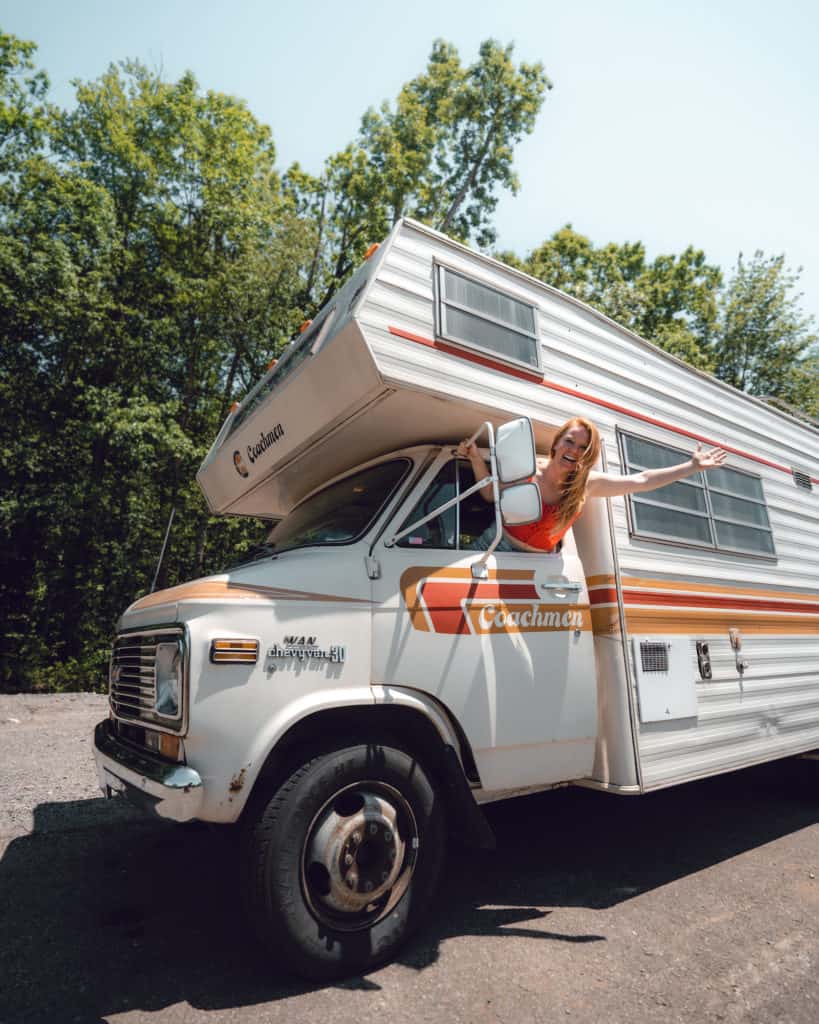 woman leaning our of her driver's window of her RV