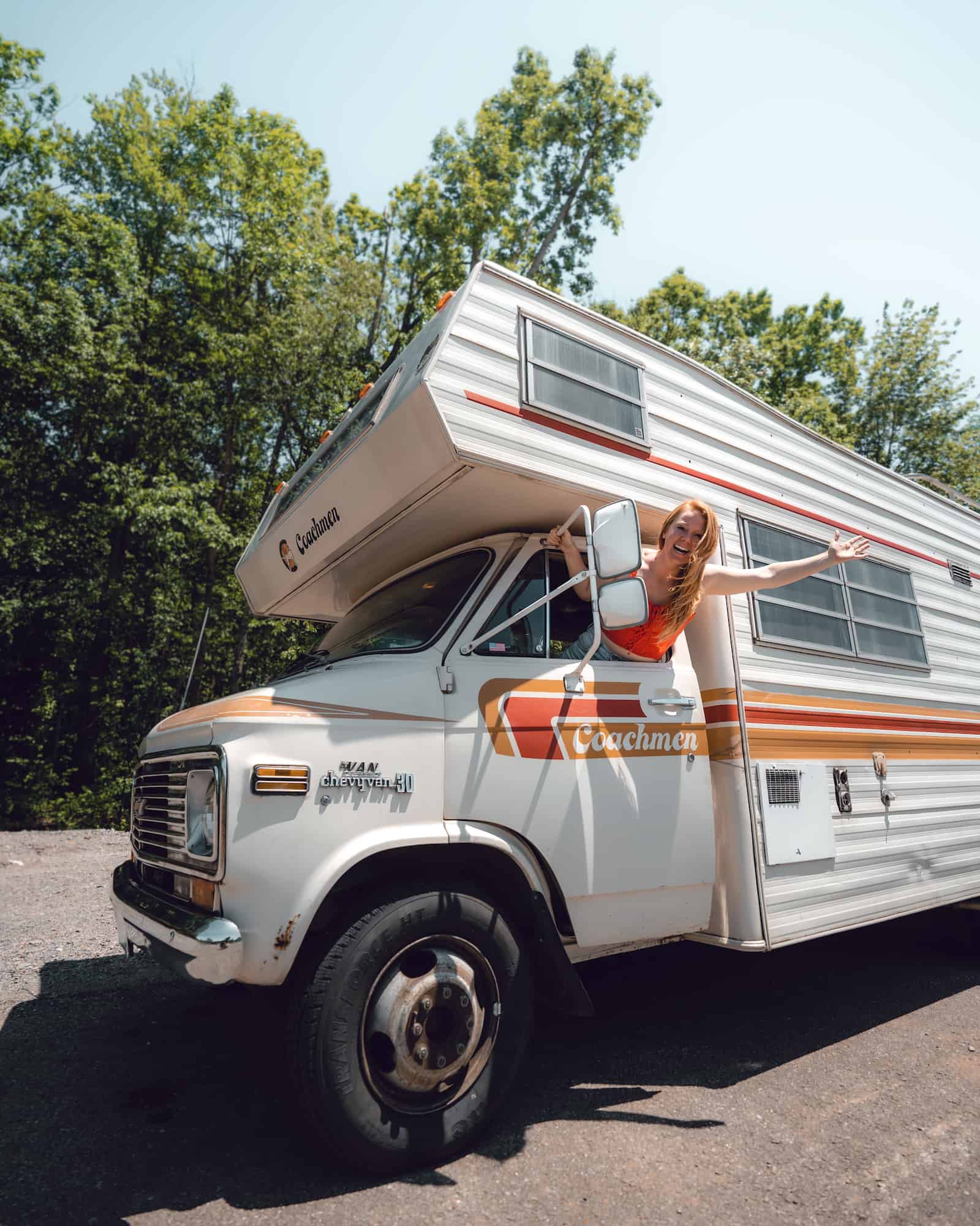 class c rv endless adventure woman sticking her hands out the window of her RV