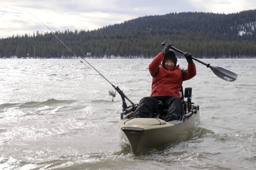 woman in fishing kayak with fish finder