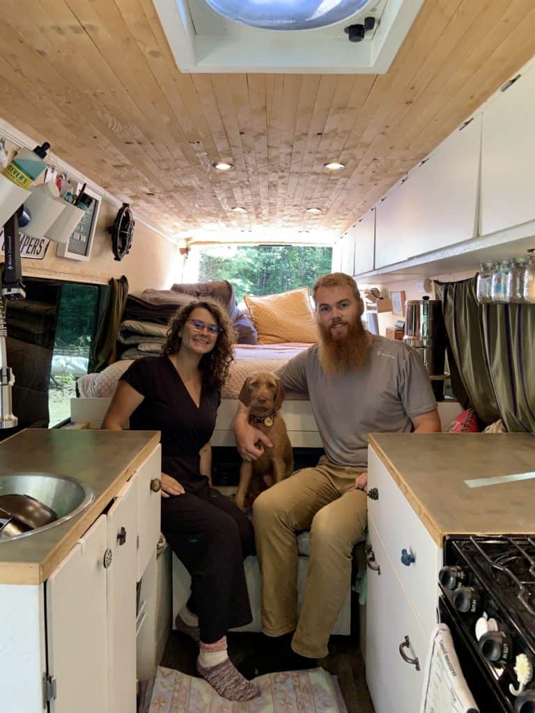 Logan, David and their dog inside of their van