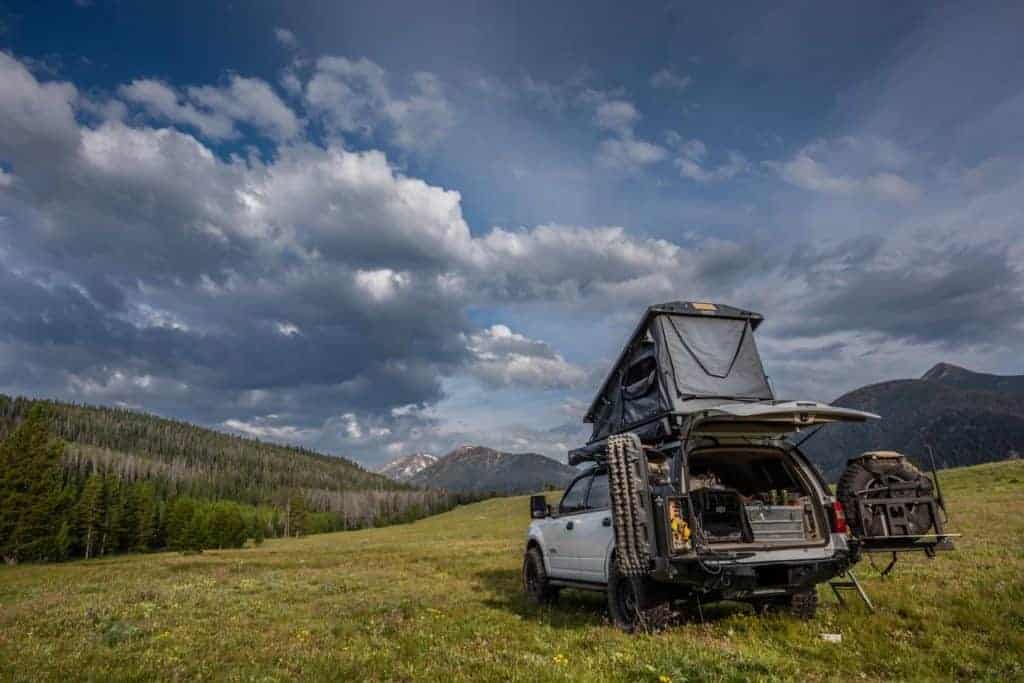 overlanding rig set up in a valley
