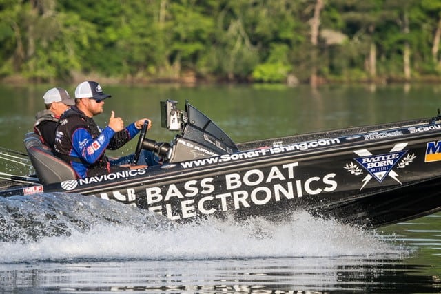 Miles Burghoff driving his bass boat giving the "thumbs up"