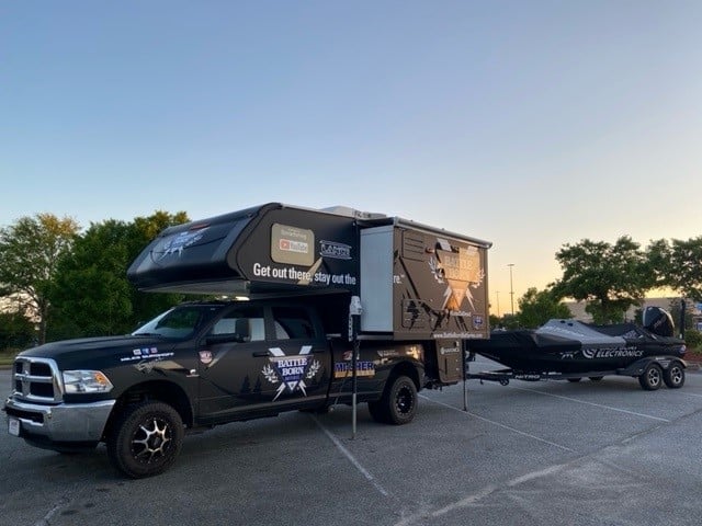 Miles' truck camper pulling his bass boat