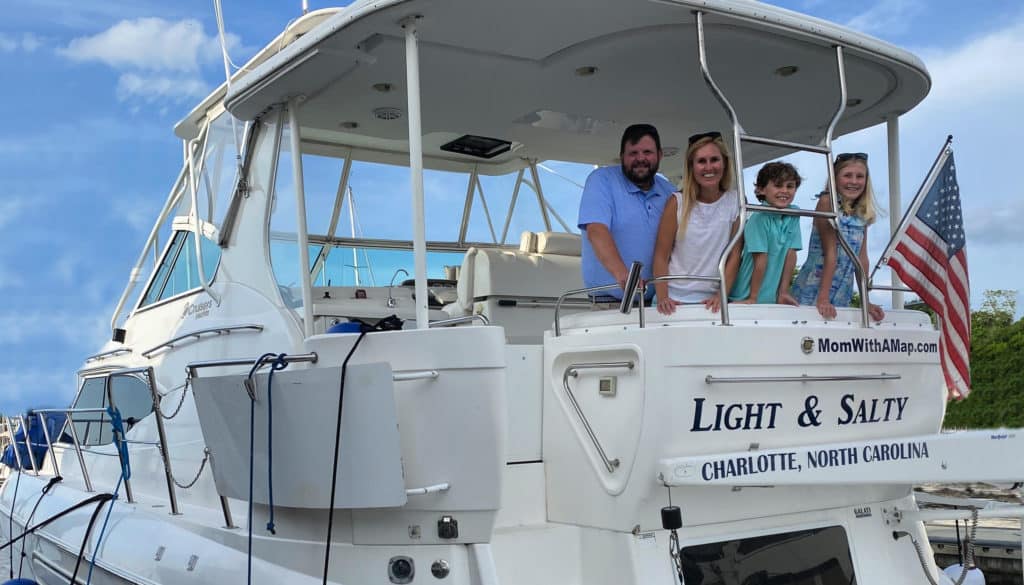 The Bowlin family on the back of their boat "Light & Salty" smiling