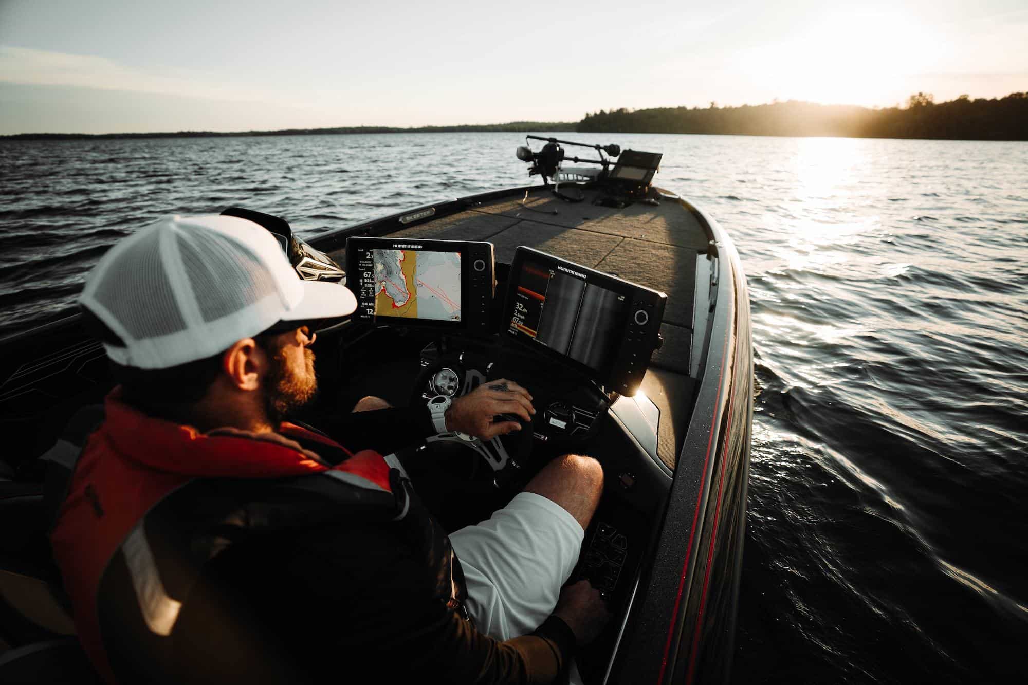 man driving a bass boat with a fish finder turned on