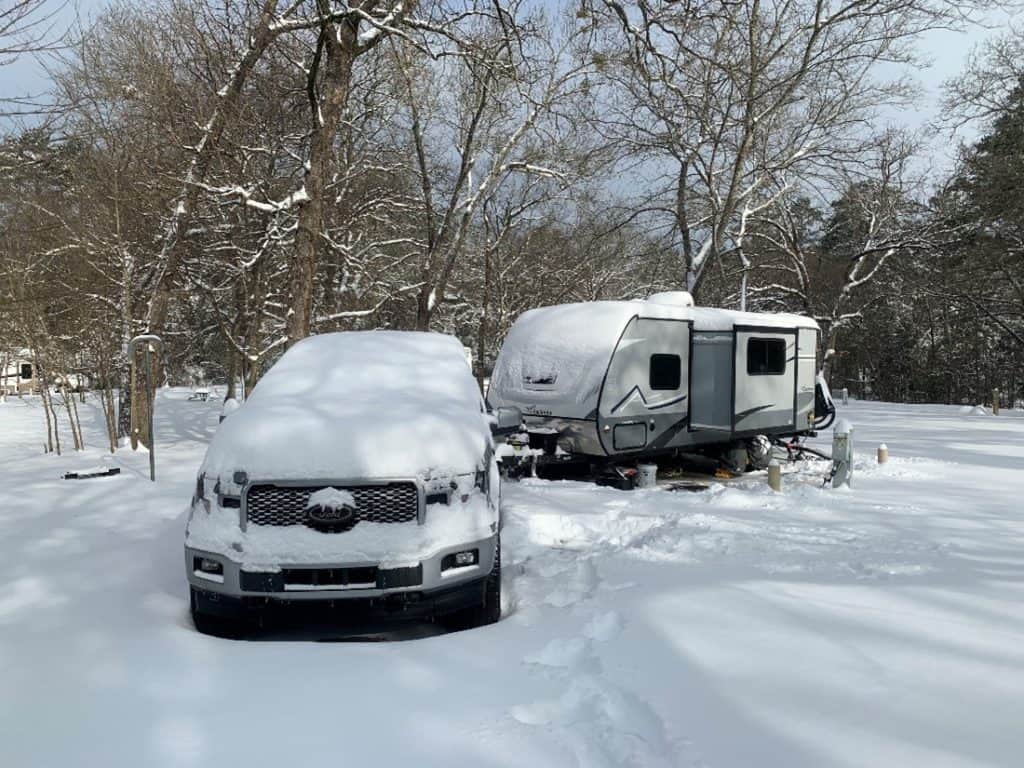 Truck and towable RV covered in snow