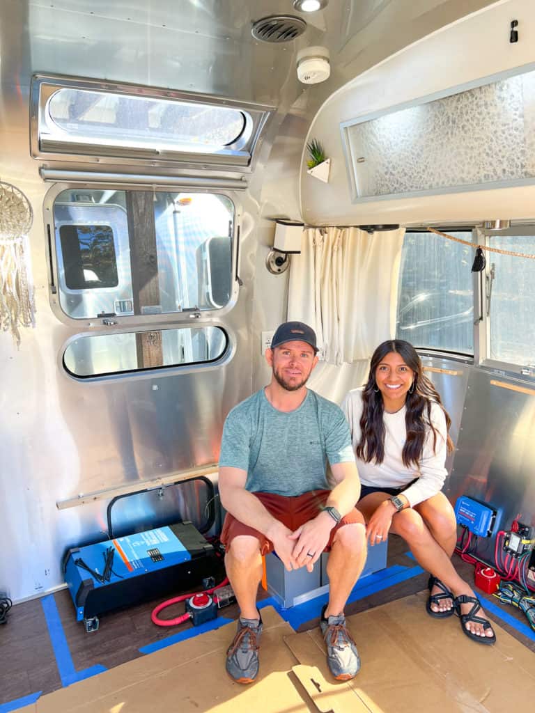 Essentially Streaming couple inside of their Airstream