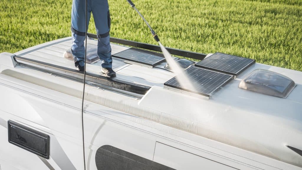 sparying solar panels with hose