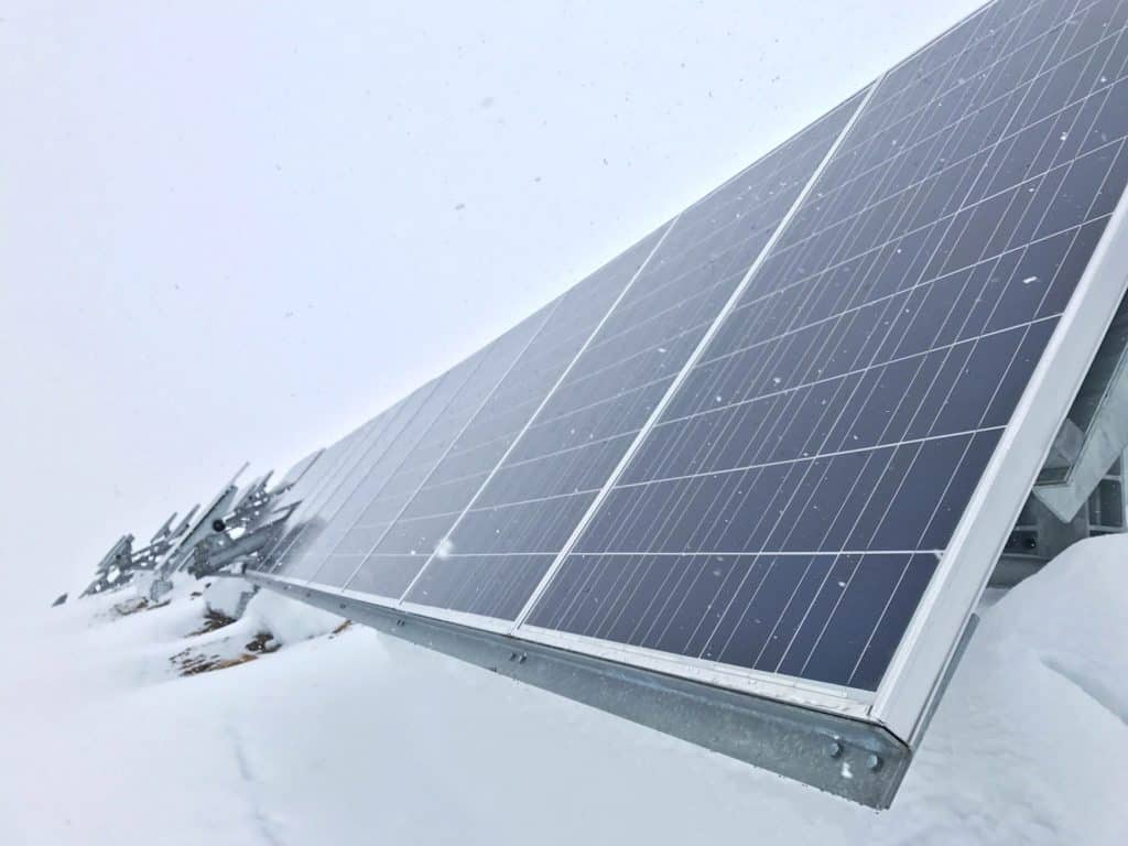 solar panels with snowy cloudy sky