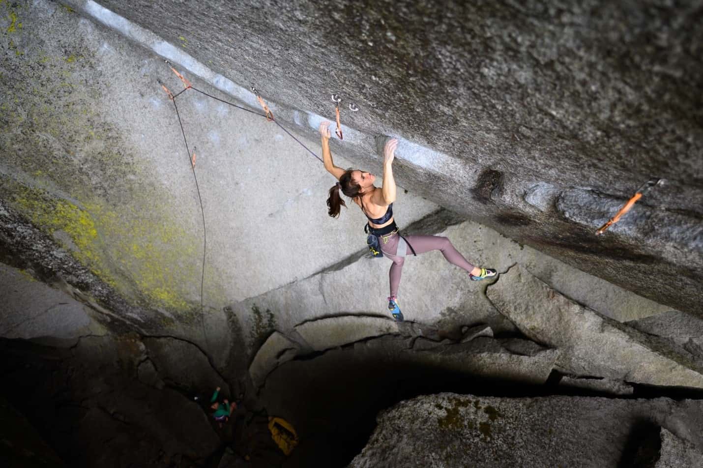 Paige Claassen scaling a rock wall