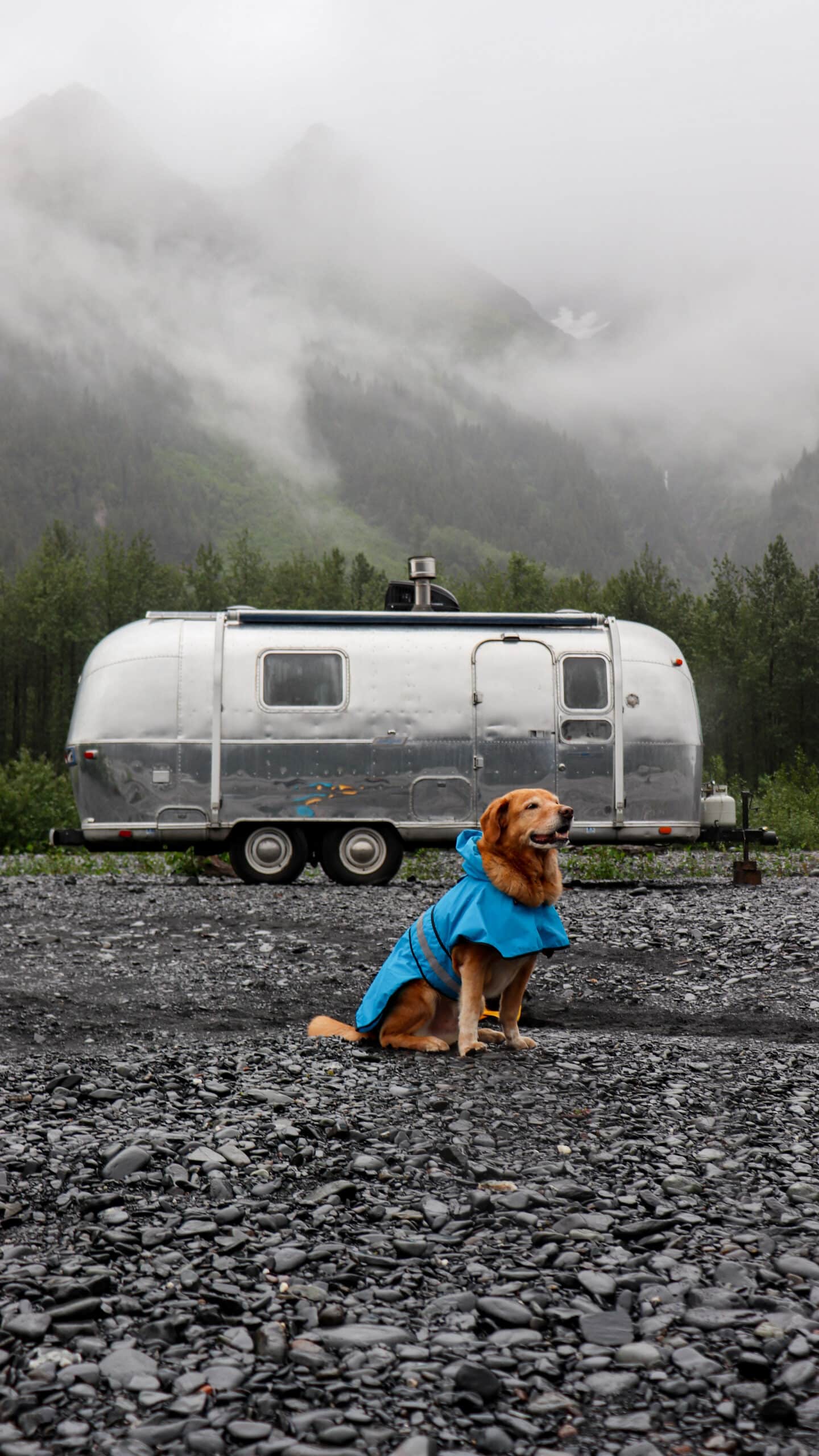 Trip in a Rain Coat in Front of Slow Car Fast Home's Airstream in Alaska