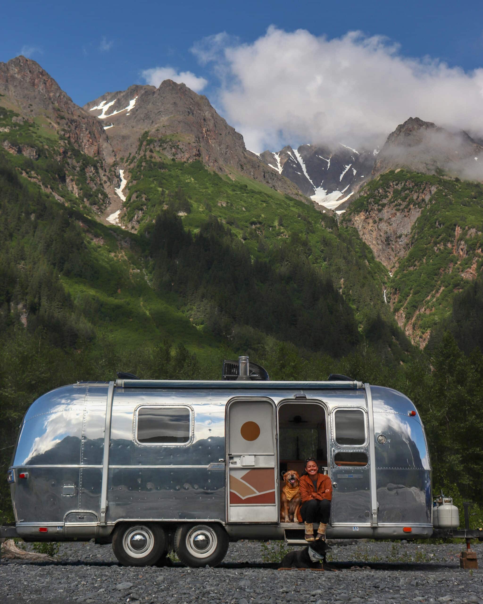 Trip and Danielle in the Airstream in Front of Tall Mountains in Alaska