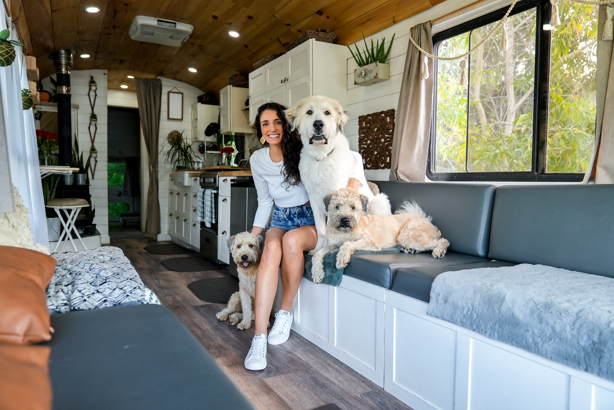 Francesca and Pups inside of her converted skoolie