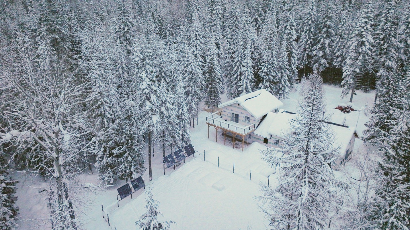 Drone shot of The Johnson's Off Grid Home covered in snow