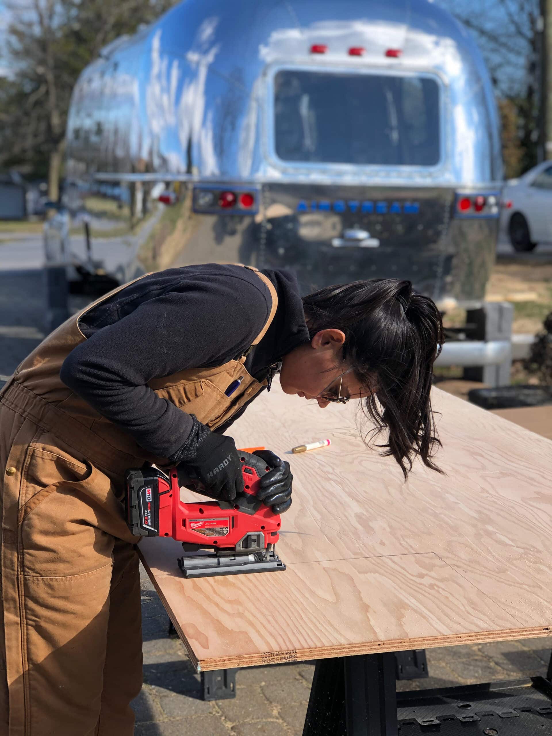 Danielle Cutting a New Subfloor for the Airstream Renovation
