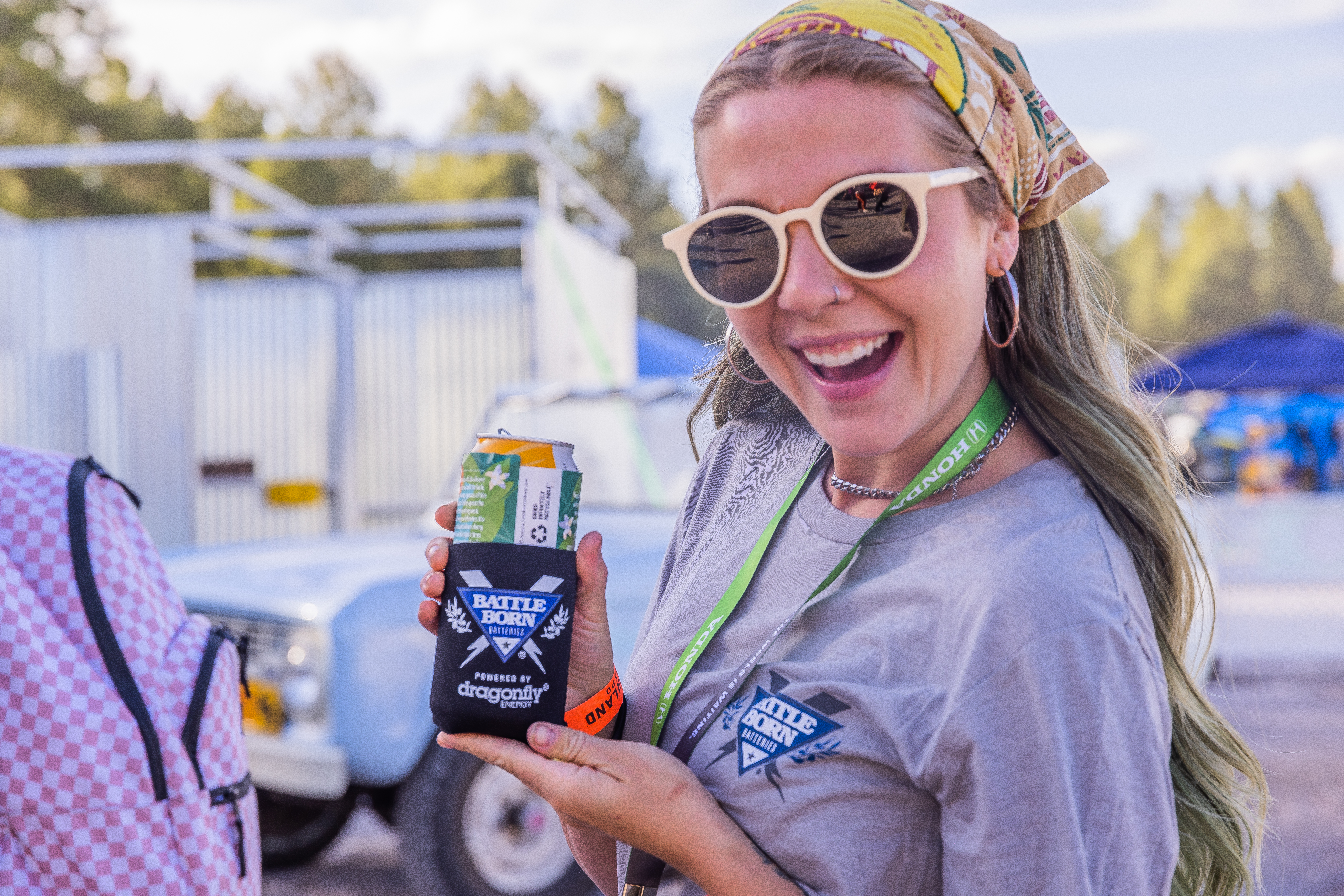 Emily from Arbour Season Showing Off Battle Born Batteries Merch at the Overland Expo