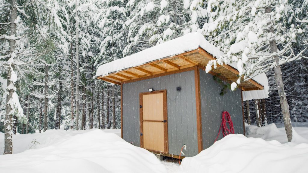 off grid cabin in a snowy winter