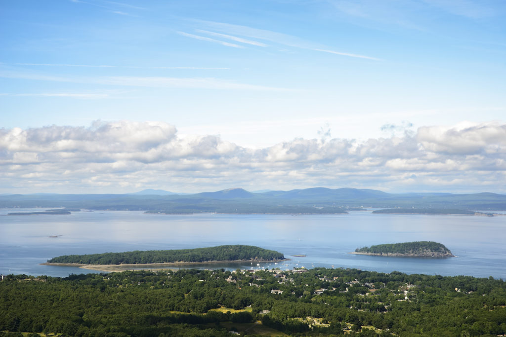 A Mountainside view of Bar Harbor and Bar Island including the low tide connecting land bridge.